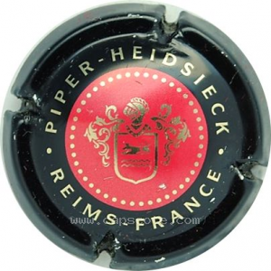Capsule Contour noir, centre rouge et or.